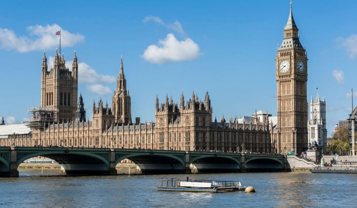 The Palace of Westminster and the clock tower commonly known as Big Ben stand beside the River Thames on a clear day.